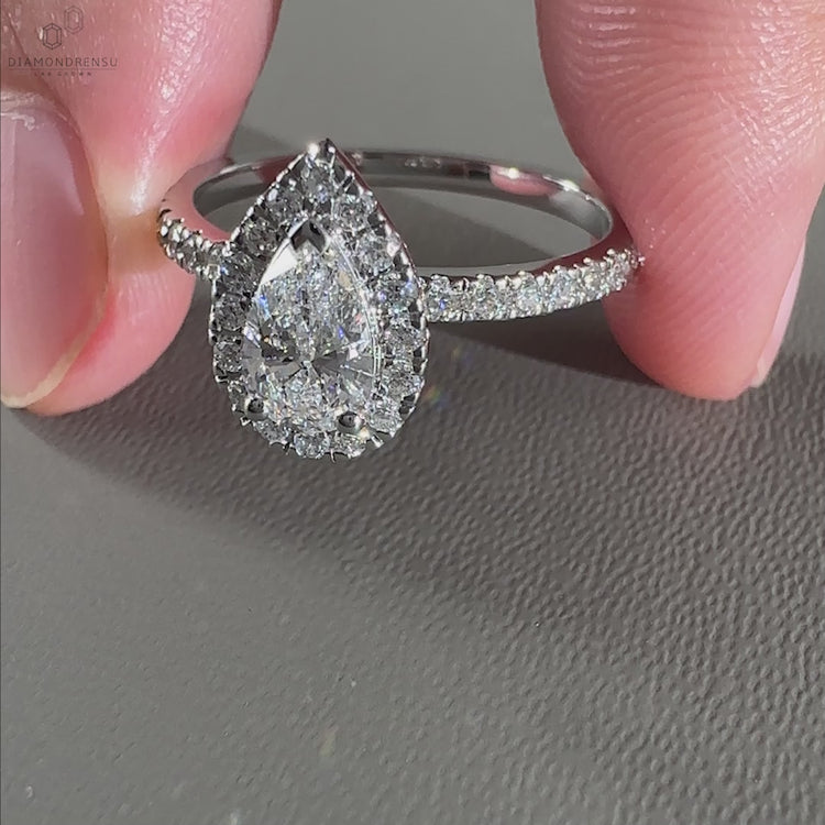 Elegant pear halo ring featuring a beautiful prong setting.
