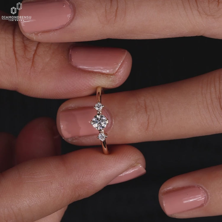 Handmade round diamond engagement ring with side stones in a yellow gold setting