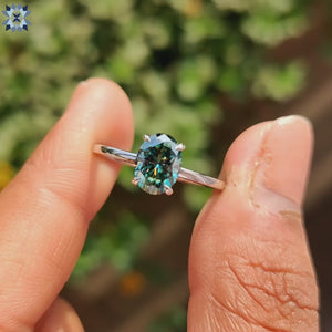 Diamondrensu ring with vibrant cyan blue oval moissanite.