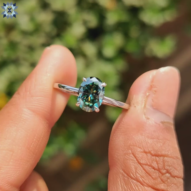 Diamondrensu ring with vibrant cyan blue oval moissanite.