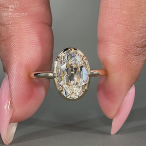 Oval old European cut solitaire engagement ring with simple design.
