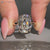 Cushion old mine cut ring in a solitaire style.