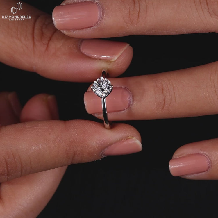 Round solitaire engagement ring with a stunning white gold band.
