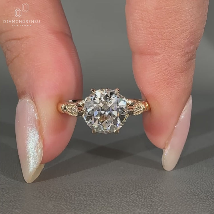 Round cut diamond in yellow gold cathedral setting.
