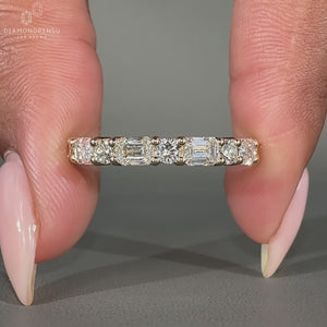 Emerald and round wedding band designed with alternating diamond shapes.
