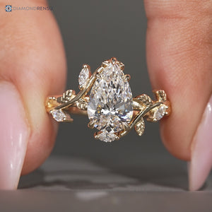Pear cut lab grown diamond ring with marquise stones.