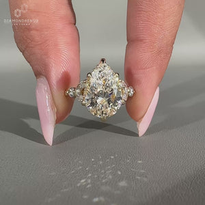 Diamondrensu engagement ring with pear cut diamond, hidden halo, and yellow gold.