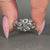 Round center stone paired with marquise and round side stones.