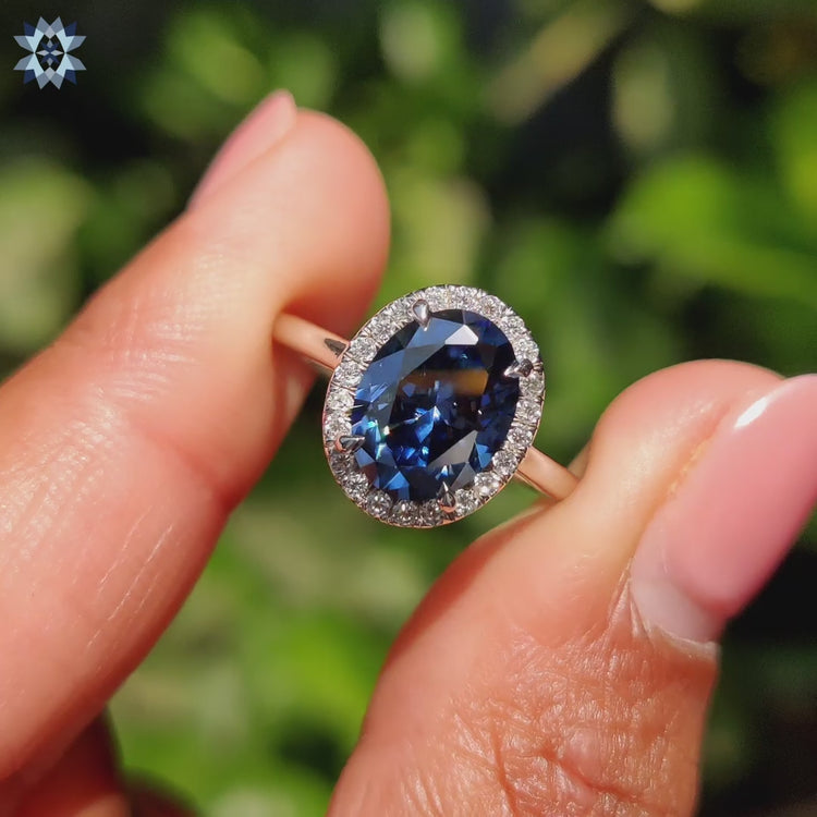 The blue moissanite engagement ring shines with brilliant clarity.
