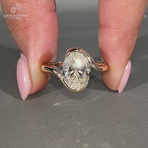 Half bezel oval cut diamond engagement ring with bypass setting.
