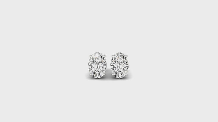 IGI certified oval stud earrings, crafted in a basket setting for a modern and secure fit.
