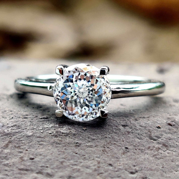 A stunning round solitaire engagement ring featuring a timeless design.
