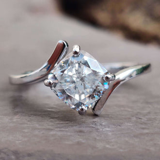 A stunning bypass engagement ring crafted with exquisite detail, displayed elegantly on a velvet box.
