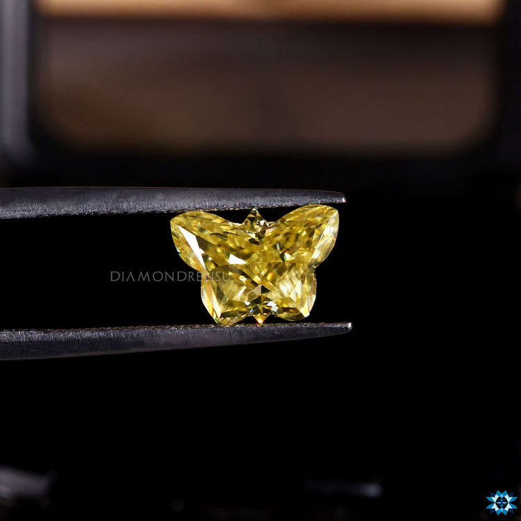 Butterfly cut Moissanite loose stone with antique yellow glow.
