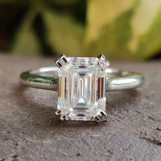A beautiful emerald cut moissanite ring in classic design.
