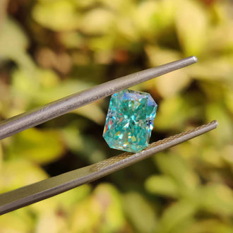 Blue moissanite loose stone in radiant cut with 1.85 carat weight and vibrant tone.
