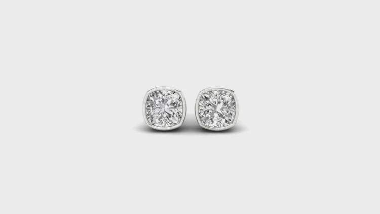 Cushion cut diamond earrings studs in a bezel stud setting, crafted with Lab Grown Diamond.
