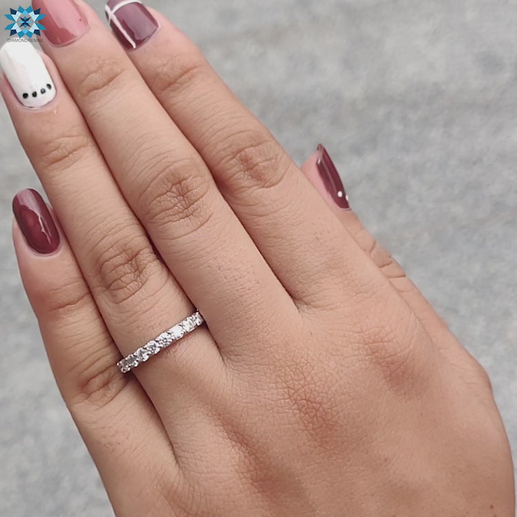 Round cut wedding band featuring a classic prong setting.