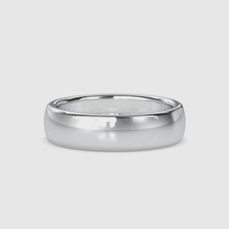 Simple gold wedding band designed for stacking, perfect for a layered look.

