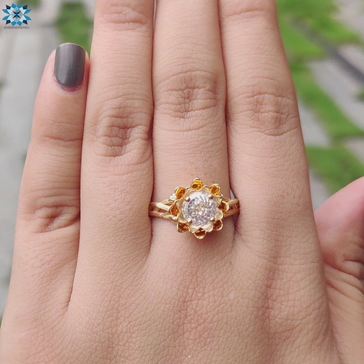 Round Portuguese cut moissanite set in a delicate floral-inspired band.
