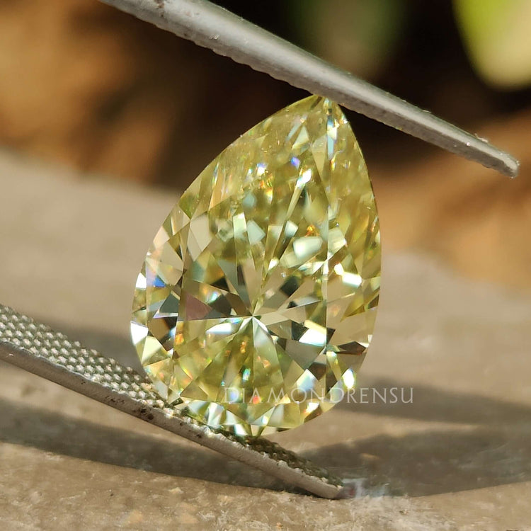 Greenish Yellow Pear Cut moissanite shown as a loose stone from Diamondresnu.
