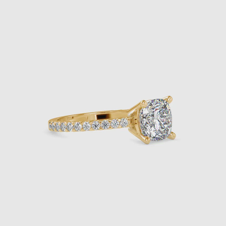 Cushion cut engagement ring featuring a 4 prong setting and pave accents.
