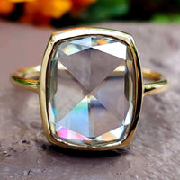 A stunning cushion cut engagement ring with a sparkling centre stone, perfect for timeless elegance.