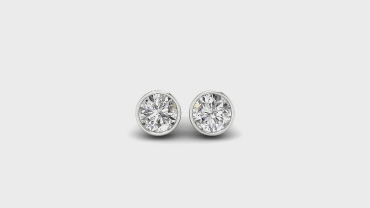Delicate white gold ear studs with diamond accents ideal for everyday wear.
