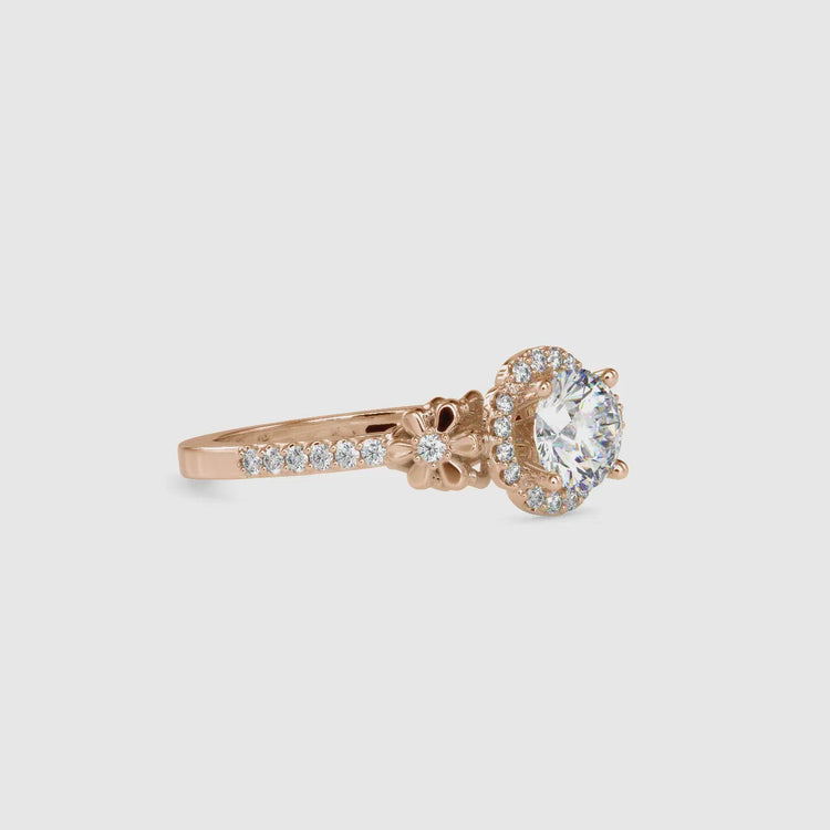 Round halo engagement ring featuring a flower-inspired design.
