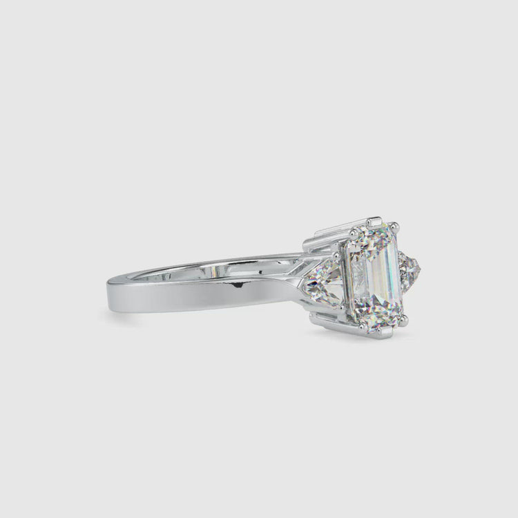 Classic three stone emerald cut diamond ring with a stunning basket setting.