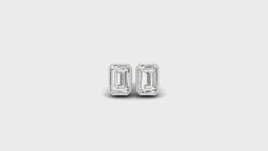 Classic bezel stud earrings featuring emerald cut diamonds, crafted with handmade jewelry.
