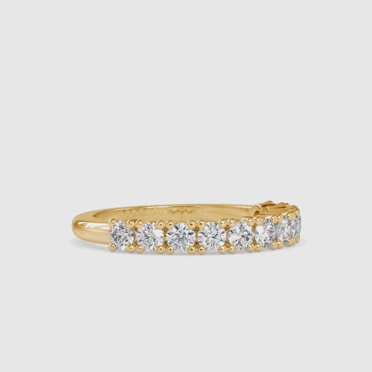 Diamondrensu wedding band featuring a gold half eternity band and shared prong setting.
