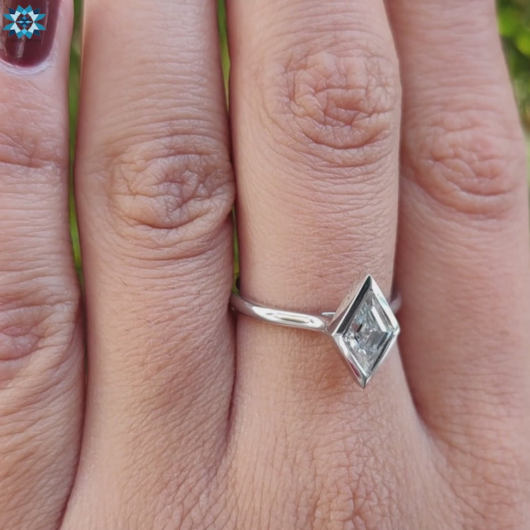 Lozenge cut moissanite ring with intricate craftsmanship.
