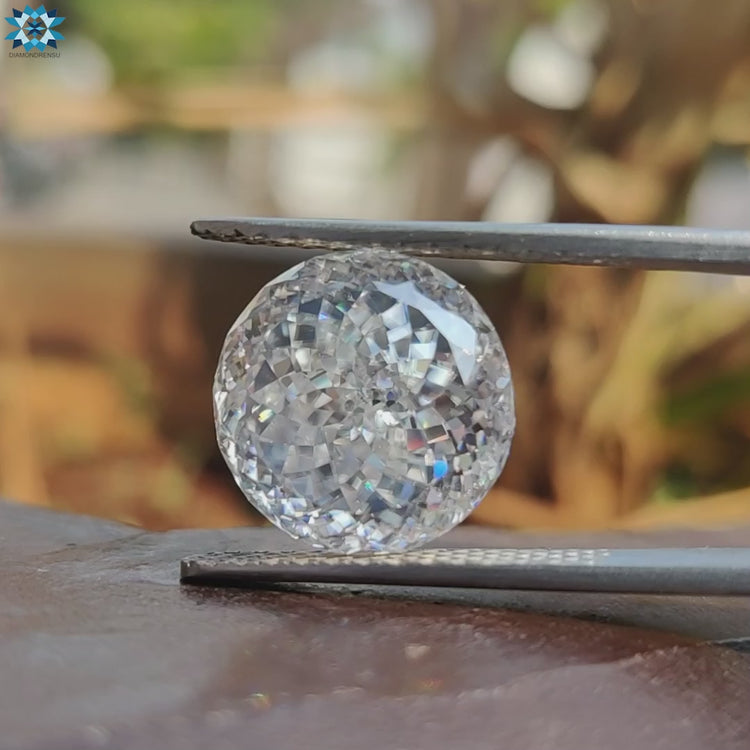 19.27 carat moissanite lays beside moissanite loose stones.
