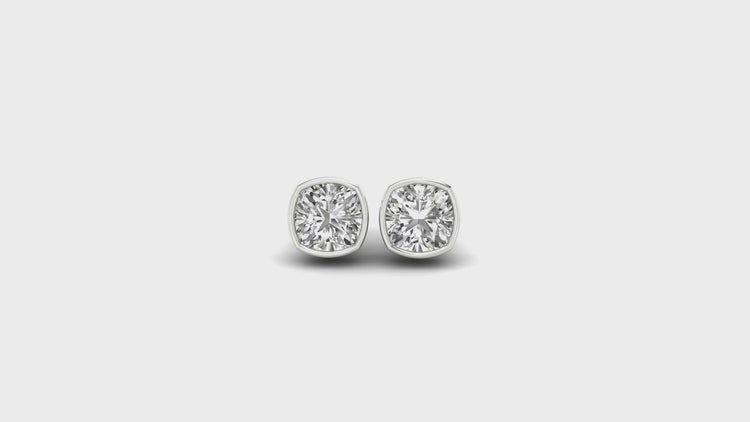 Elegant cushion bezel setting earrings with IGI certified diamonds for added brilliance.
