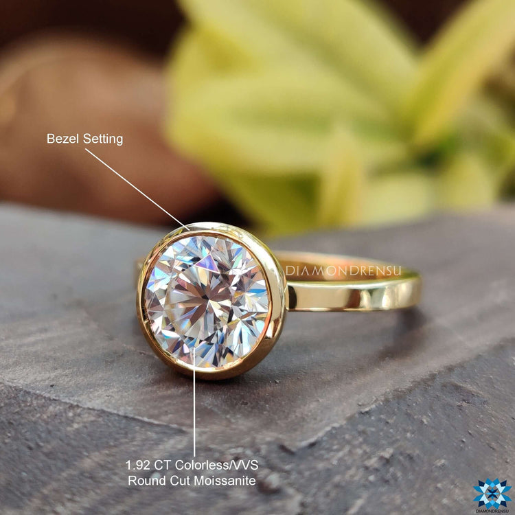 Yellow gold bezel engagement ring for a bold and stylish choice.
