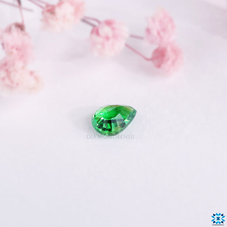 Green gemstone crafted as pear cut gemstone for birthstone for January.
