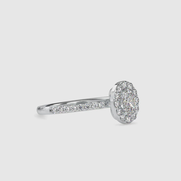 Pave diamond engagement ring with a 2 carat oval halo and a matching pave wedding band.
