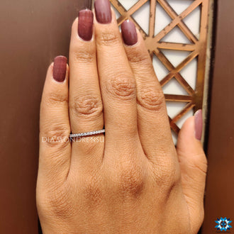 Sleek round cut wedding band with exquisite moissanite stones for a flawless design.