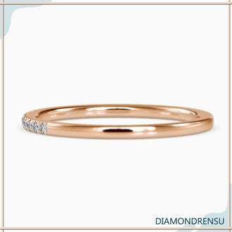 Gold eternity band with round diamonds and minimalist band style.
