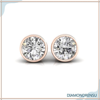 Classic bezel set diamond earrings with a secure bezel setting in white gold.
