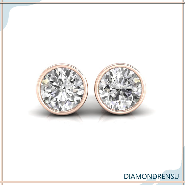 Classic bezel set diamond earrings with a secure bezel setting in white gold.
