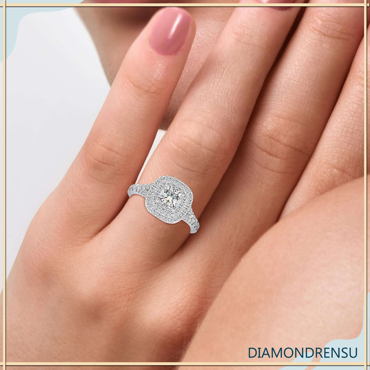 Cushion cut double halo engagement ring with a split shank design and pave diamond accents.