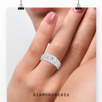 Nature ring with a bezel set engagement ring and side stones.
