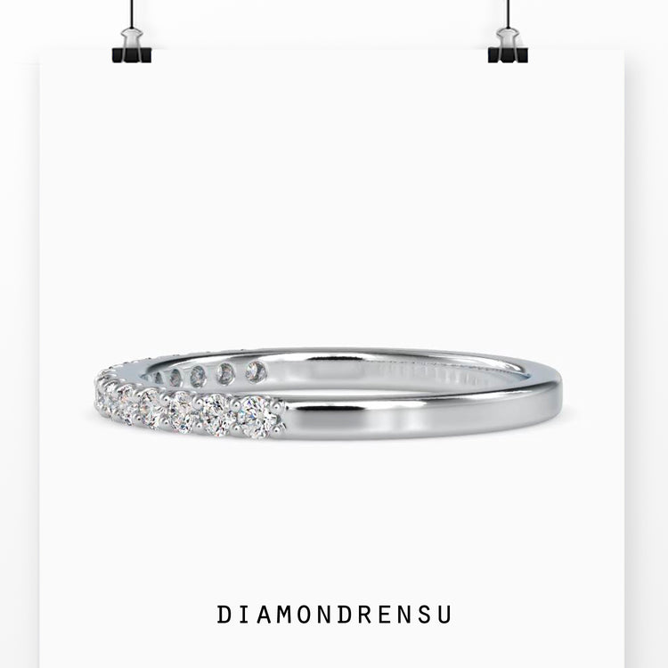 Half eternity wedding band with a diamond half eternity in rose gold.
