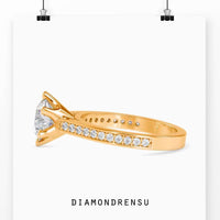 Channel set engagement ring with a rounded diamond in a 6 prong ring setting, perfect for proposals.