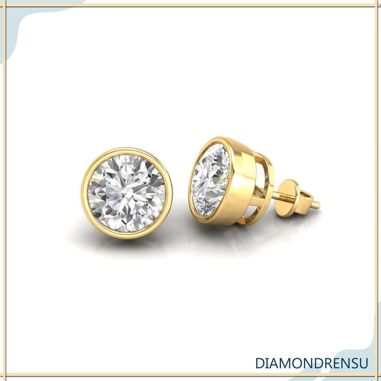 Timeless gold round earrings featuring bezel set diamond studs for a luxurious touch.

