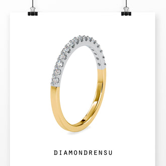 Lab grown diamond wedding band with brilliant cut diamonds in a gold setting.
