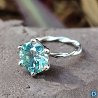 Twist engagement ring crafted with a round solitaire stone.
