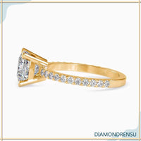 Cushio cut diamond with a basket ring setting and pave engagement band.
